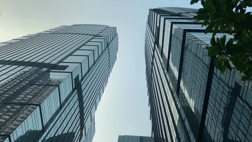 Office tall building. Low angle view of skyscrapers office building in central business district with blue sky