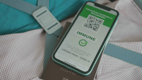 A close-up of a smartphone displaying an international vaccination certificate, confirming immunity against COVID-19. The certificate features a QR code for verification, set on a stylish background. - Powered by Shutterstock - Get 15% off with code: PIKWIZARD15