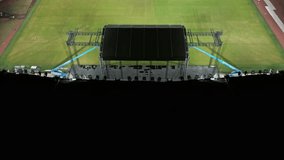 Music concert stage set up buildup construction. stadium football pitch being prepared to host a music concert. sports stadium as technicians set up the stage for the live music event. - Powered by Shutterstock - Get 15% off with code: PIKWIZARD15