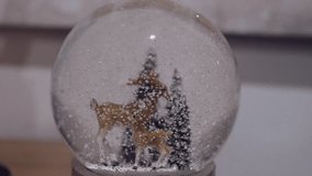 winter snow globe scene with deer figures and snowy pine trees - Powered by Shutterstock - Get 15% off with code: PIKWIZARD15