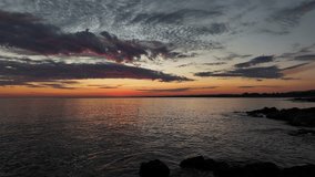 In Maldonado, Uruguay, just after sunset, the calm sea sends gentle waves between coastal rocks. The sky still holds warm tones, and the water reflects the fading light of day. - Powered by Shutterstock - Get 15% off with code: PIKWIZARD15