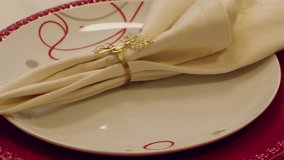 Christmas table plate with gold reindeer napkin ring on red and white festive setting - Powered by Shutterstock - Get 15% off with code: PIKWIZARD15