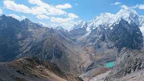 Epic aerial pull back shot from San Antonio Pass reveals panoramic snow-capped peaks, turquoise glacial lakes, and vast wild valleys of the Cordillera Huayhuash in Peru. - Powered by Shutterstock - Get 15% off with code: PIKWIZARD15