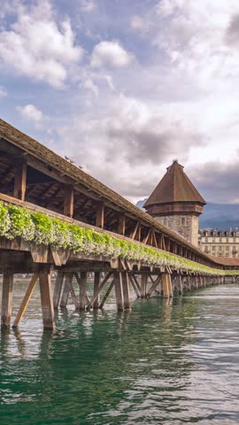 Lucerne (Luzern) Switzerland time lapse city skyline at Chapel Bridge (Vertical)