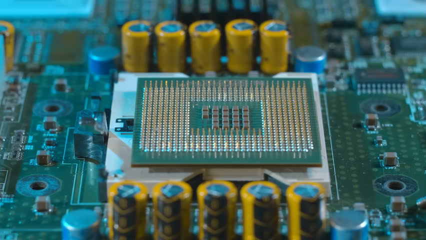 Powerful modern server computer motherboard with two processors. In inverted processors are a lot of conductive legs (contacts, pins) are visible. Closeup. Macro. Follow focus. Shot in motion