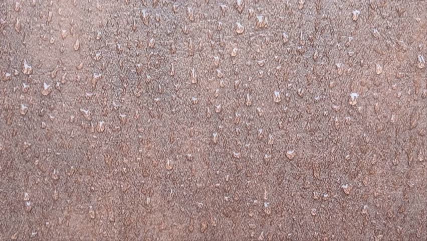 Abstract video of water droplets covering a rusty metal surface. The macro shot highlights the texture and detail, creating a moody and industrial ambiance - Powered by Shutterstock - Get 15% off with code: PIKWIZARD15