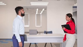 International partners team Indian businessman and cheerful businesswoman engage in a friendly handshake within a bright modern office. Both are dressed in formal business attire. - Powered by Shutterstock - Get 15% off with code: PIKWIZARD15