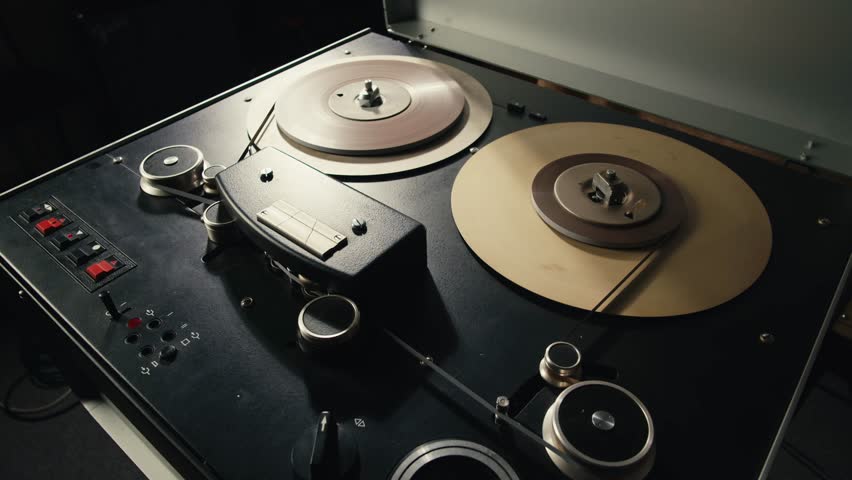 Tape audio music player, studio magnetic tape, vintage retro spool reel to reel player and recorder, magnetic tape data storage close up, music studio. 