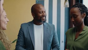 Group of diverse colleagues applauding black businessman in office space during daytime - Powered by Shutterstock - Get 15% off with code: PIKWIZARD15