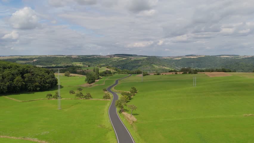 Road through nature in Luxembourg, landscape aerial view, summer meadow, field and forest, travel countryside, agriculture