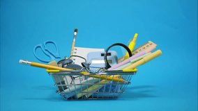 Shopping basket with school supplies isolated on blue background. Stop motion animation - Powered by Shutterstock - Get 15% off with code: PIKWIZARD15