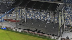Music concert stage set up buildup construction. stadium football pitch being prepared to host a music concert. sports stadium as technicians set up the stage for the live music event. - Powered by Shutterstock - Get 15% off with code: PIKWIZARD15