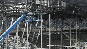 Music concert stage set up buildup construction. stadium football pitch being prepared to host a music concert. sports stadium as technicians set up the stage for the live music event. - Powered by Shutterstock - Get 15% off with code: PIKWIZARD15