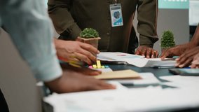 Multiethnic team reviewing analytics in a late night company briefing after hours, projections and data insights to align business goals with expectations in modern office space. Camera B. - Powered by Shutterstock - Get 15% off with code: PIKWIZARD15