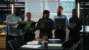Portrait of multiethnic business team collaborating late at night, assembling in a dark office after hours and working on enterprise development. Diversity within the advisory board group. Camera A. - Powered by Shutterstock - Get 15% off with code: PIKWIZARD15