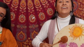 Women playing drums and singing during a cacao ceremony, creating a mystical and energetic atmosphere - Powered by Shutterstock - Get 15% off with code: PIKWIZARD15