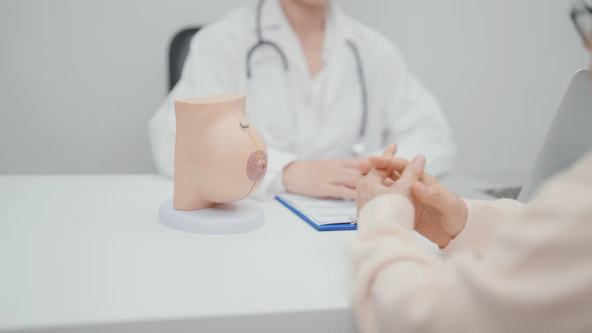 Elderly woman Patient consultation with doctor for Breast Augmentation Surgery, October Breast Cancer Awareness month, implant, Diagnosis, Beauty woman enlargement and medical healthcare concept