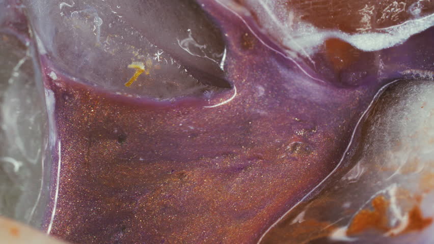 Pour liquid. Ice texture. Blur purple orange blue color shiny ink flowing white water floating on abstract frost acrylic background.