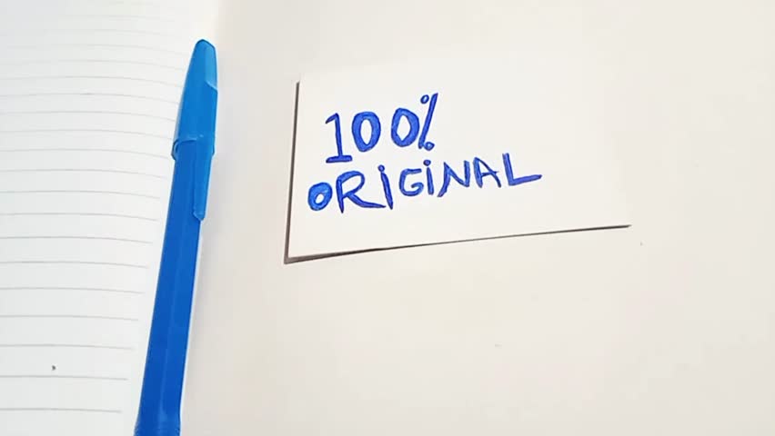 4K footage of a handwritten “100% ORIGINAL” note on white paper next to a blue pen and notebook. Captured in natural lighting, perfect for originality concept, branding, or motivational themes.