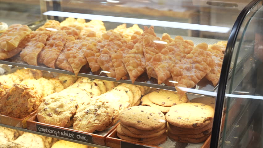 Cookies and cakes on display in a bakery, Australia