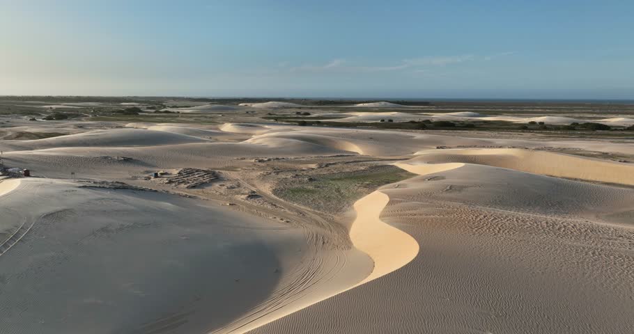Flyover sand dunes and a small green vegetation patch at Lençóis Maranhenses National Park, Maranhão, Brazil