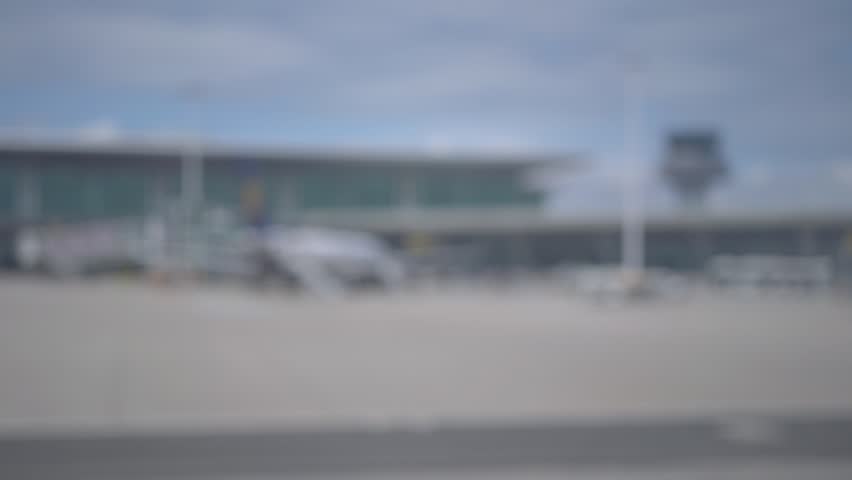Blurred airplane taxiing on airport runway