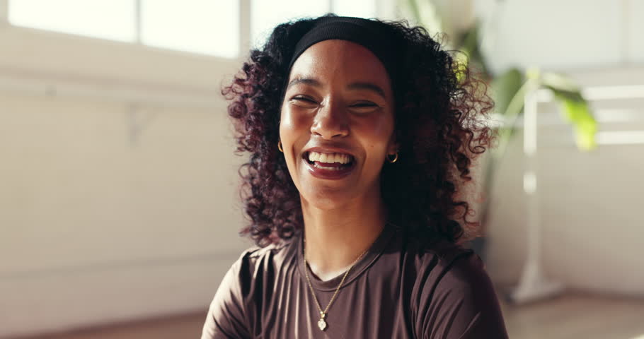 Face, funny and yoga with woman in studio for holistic exercise, inner peace or mindfulness. Healing, rest and wellness with happy person laughing on floor for awareness, fitness break or recovery