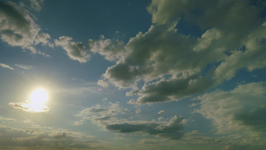A Serene Sky with Beautiful Sunlight Accompanied by Fluffy Clouds in the Afternoon