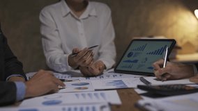 Business team collaborating late, analyzing financial data and strategizing using a digital tablet for informed decision making and effective planning - Powered by Shutterstock - Get 15% off with code: PIKWIZARD15