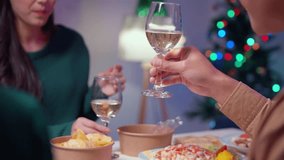 Couple savoring a festive christmas dinner, enjoying white wine and sharing laughter in a warm, beautifully decorated home - Powered by Shutterstock - Get 15% off with code: PIKWIZARD15