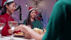 Group of friends gathered around a table, hands clasped together, offering a prayer before enjoying their festive christmas dinner. Warmth and gratitude fill the atmosphere - Powered by Shutterstock - Get 15% off with code: PIKWIZARD15