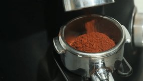 Coffee flows in thin dark stream into metal portafilter. Removable device of coffee machine completely filled with coffee powder slow motion - Powered by Shutterstock - Get 15% off with code: PIKWIZARD15