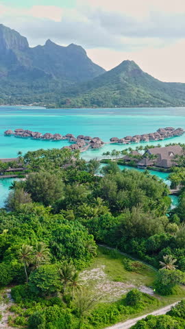 Bora Bora Island French Polynesia. Vertical Drone Shot of Luxury Resort With Villas Over Lagoon Water