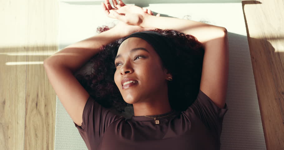 Thinking, woman and relax on mat in yoga class of fitness break, holistic exercise and inner peace. Above, female person and resting for zen, stress relief and spiritual recovery from pilates routine