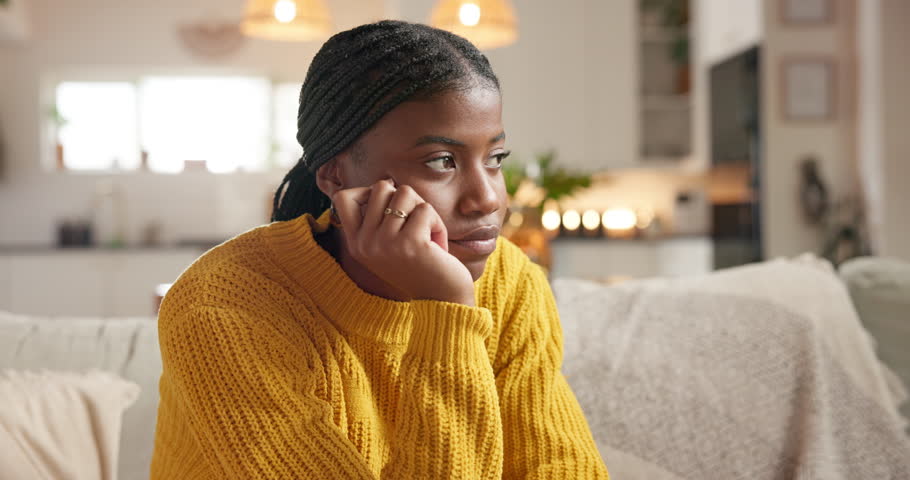 Thinking, stress and sad black woman in home with anxiety, worry and contemplating decision for debt. Unhappy, reflection and person in living room with challenge, regret and financial crisis
