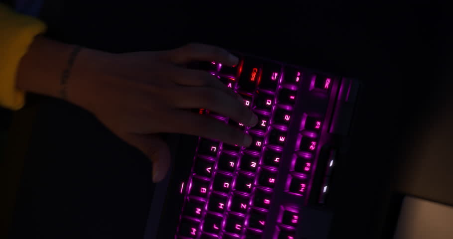 Female Immersed in a Competitive Online Video Game at Her Home Setup in a Neon-lit Room. Black Gamer Winning a Match in a 3D Shooter Tournament. Swirling Robotic Camera Footage