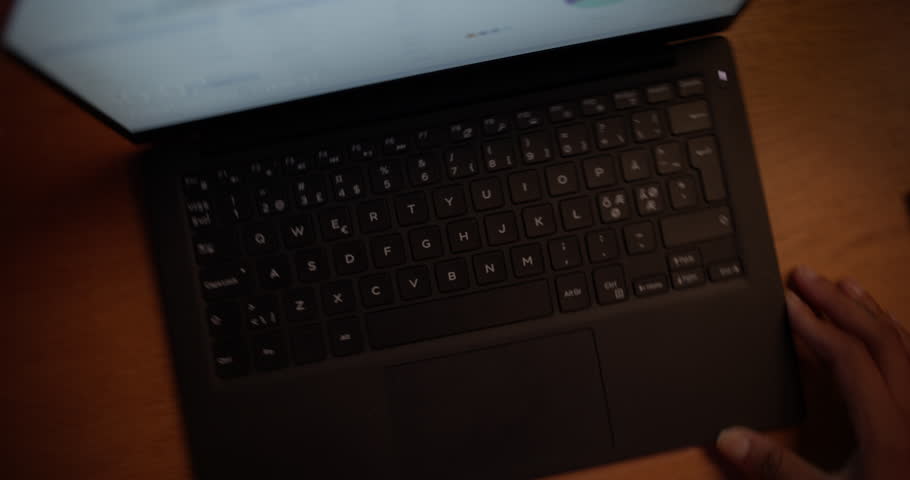 Cheerful Black Female Opening Up a Laptop and Starting to Work. Portrait of a Beautiful African Girl Sitting Behind a Table at Home in a Living Room, Using Computer. Dynamic Robot Camera Footage