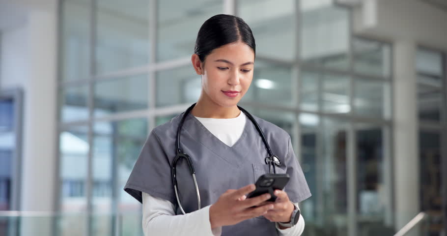 Doctor, woman or typing with phone in hospital for telehealth, healthcare update or research. Medicine, professional and smile with smartphone in clinic for planning schedule or reading health report