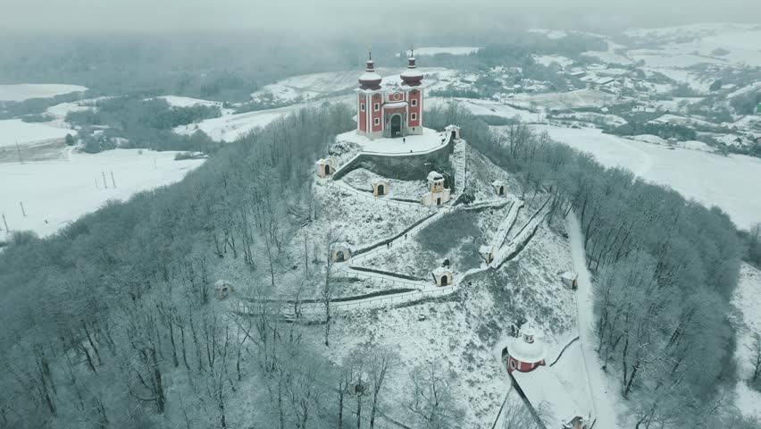 Landmark of Banska Stiavnica, gorgeous church on top of the snow covered hill 4k