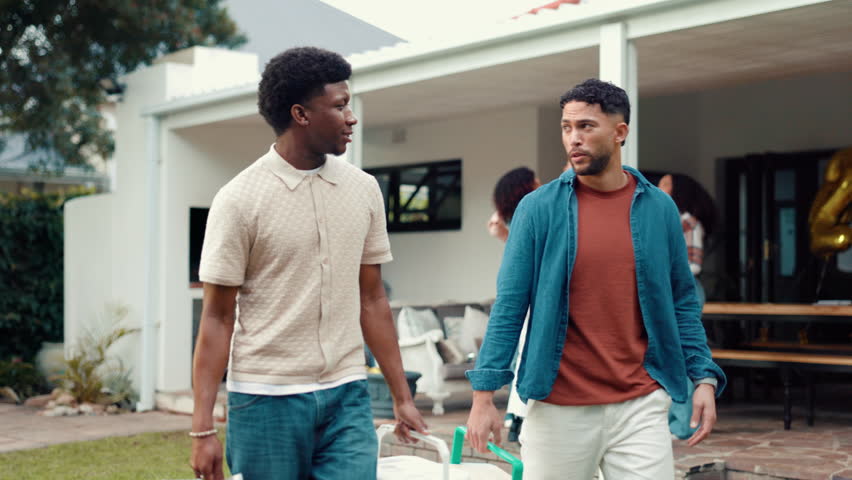 Happy, men and friends with cooler box at house for barbecue, celebration and New years party. People, talking and walk with bbq equipment, lunch reunion and prepare for social gathering in backyard