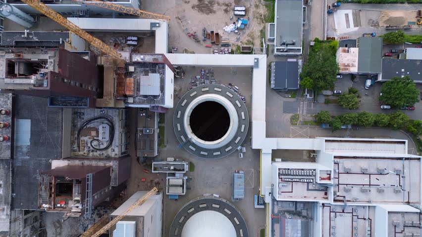2 crane dismantling a power plant during a demolition process. Perfect aerial view flight drone camera pointing down
