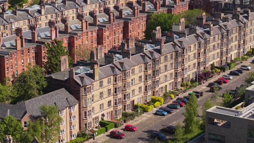 Drone footage revealing the uniform architecture and layout of houses in a traditional Edinburgh neighborhood, highlighting urban charm and harmony
