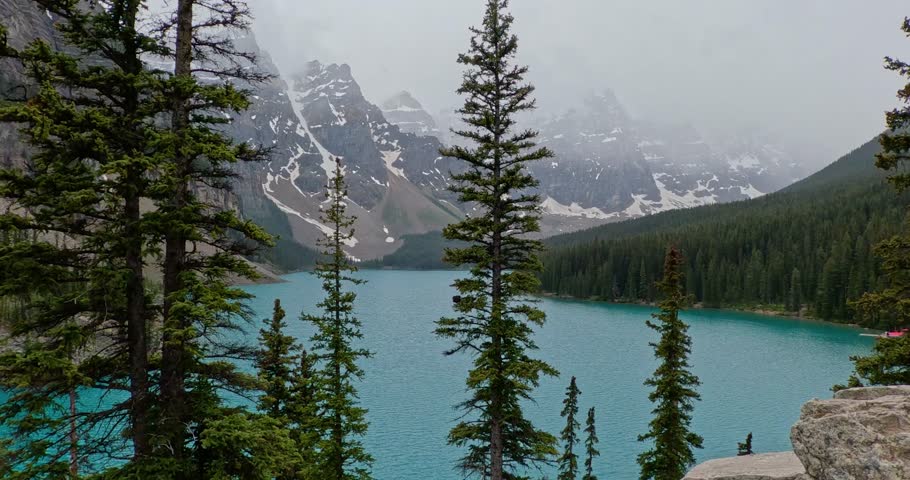 Mountain side view of the beautiful azure blue waters of Moriane Lake in Banff National Park in Alberta Canada.