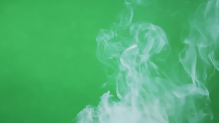 Dynamic gray white smoke swirls against green screen chroma key background. Moody atmosphere. Film movie special effect. Chromakey backdrop. Isolated overlay.