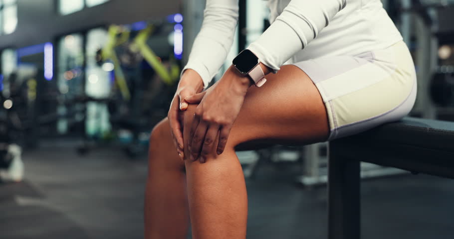 Knee pain, hands and woman at gym with fitness accident, mistake and anatomy tension or risk. Leg strain, stress or athlete with joint massage for muscle injury, bruise or tendinitis inflammation