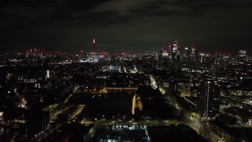 Fixed aerial of traffic at the Shadwell marina and the city of London, night