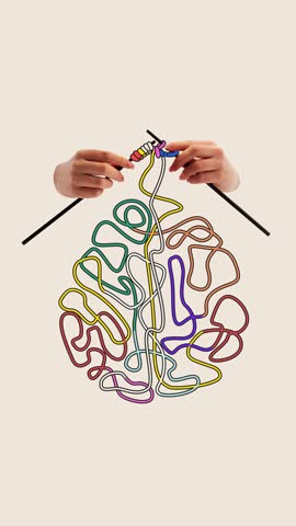Playful stop motion. Ideas in progress. Hands knit colorful tangled threads into brain, showing how bright thoughts form gradually from inner chaos. Concept of creativity, design, imagination