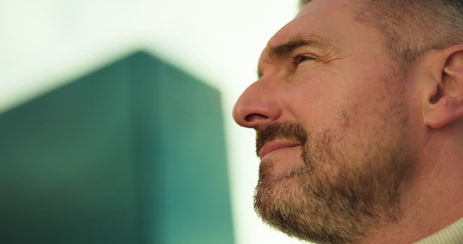 Business man, planning and thinking in city for building viewing, expansion opportunity or decision. Real estate agent, face of mature person or vision for urban development, inspiration or low angle