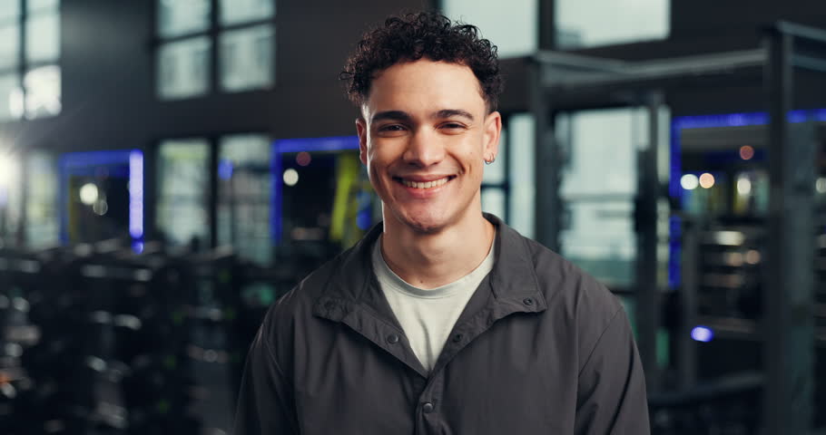 Smile, personal trainer and face of man in gym for exercise, training routine and workout. Fitness center, health club and portrait of person with confidence, pride and happy for wellness coach