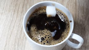 black coffee, sugar cube drops into hot black coffee, causing a splash and ripples. close-up shot with rich coffee texture, ideal for beverage, food, and lifestyle content - Powered by Shutterstock - Get 15% off with code: PIKWIZARD15